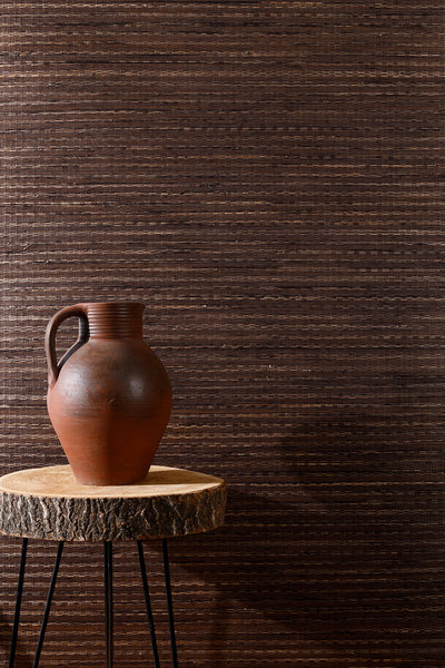 Step Into the Dark with this stunning bamboo wallpaper that brings both elegance and mystery to your space. Crafted from natural bamboo, it features intricate woven sections that add texture and depth to your walls. The rich, dark tones of this wallpaper evoke a sense of coziness and sophistication, perfect for creating a bold yet inviting atmosphere. Whether you're looking to transform a living room or a bedroom, Into the Dark is your ticket to a stylish, nature-inspired retreat